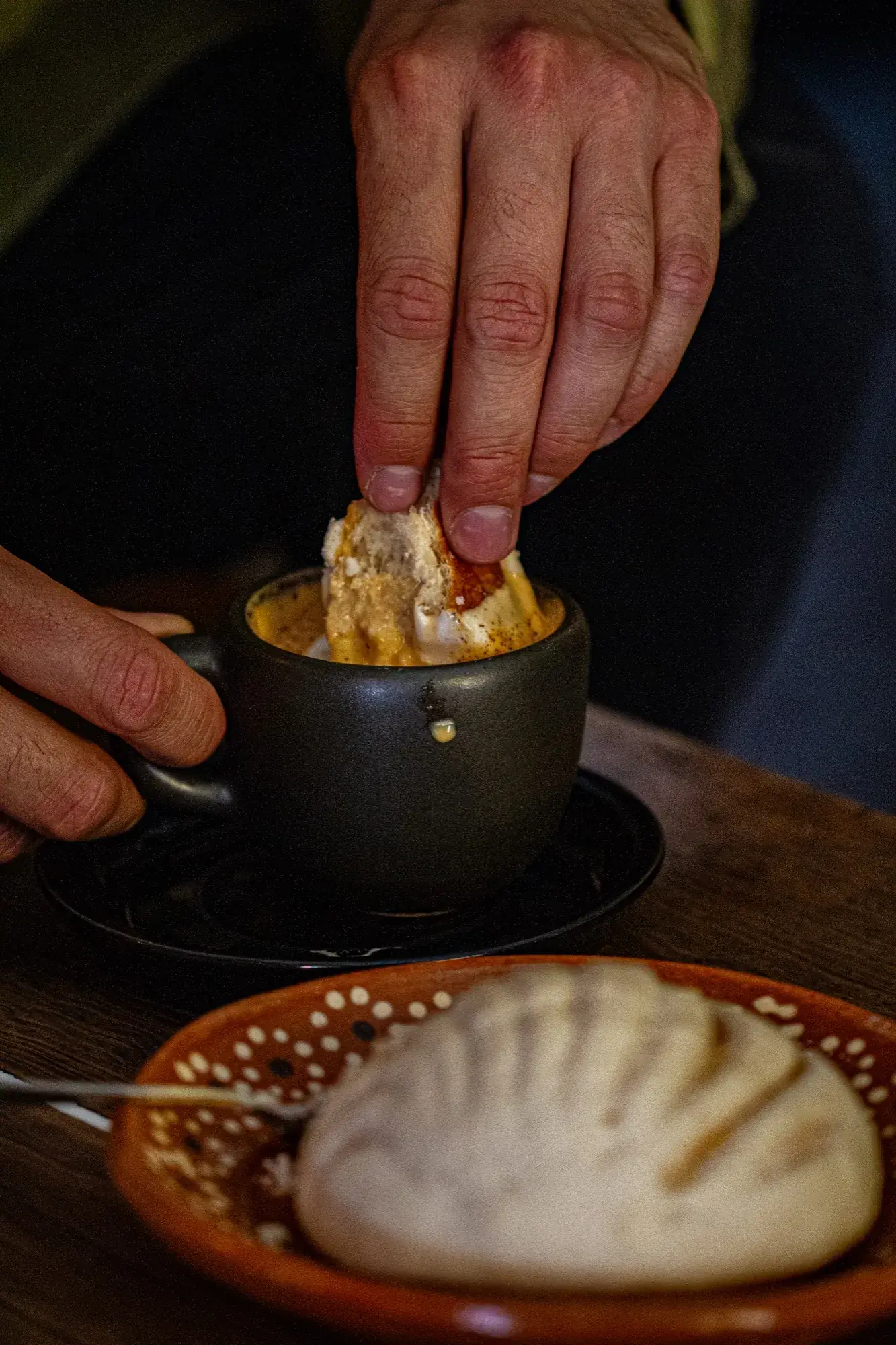 Warm coffee moment at Ki'bok — hands, latte art, and morning light
